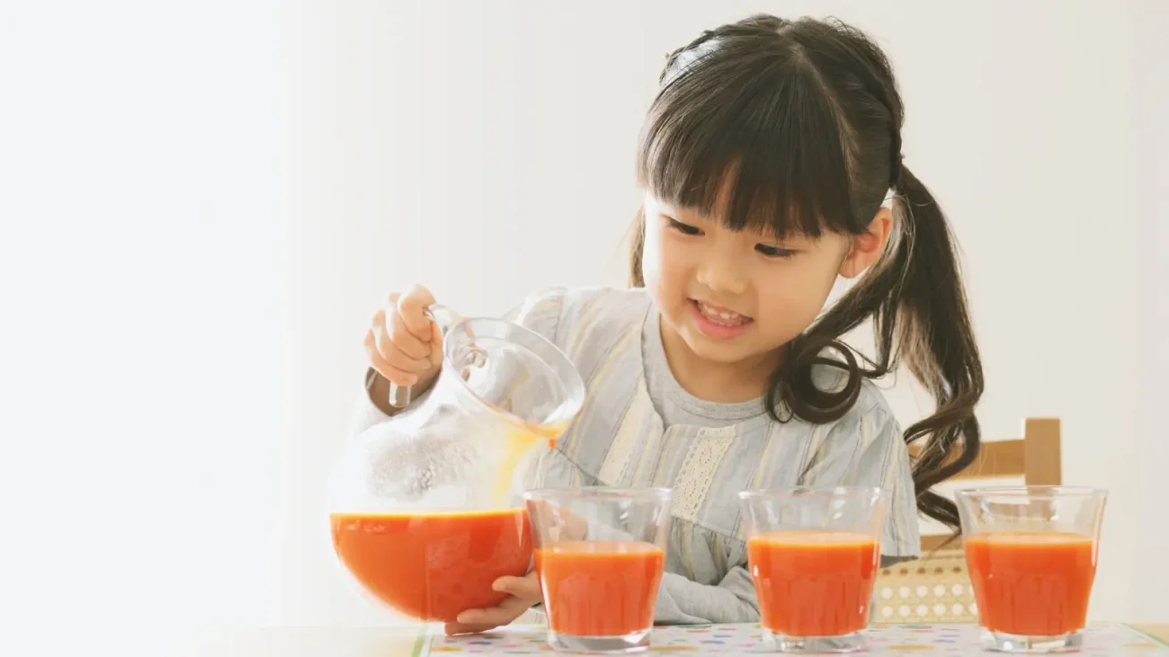 Child Performing Pratical Life Activity by pouting water from jug to equal sized glasses